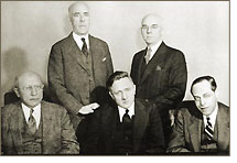 SEC Commission (1938-39): William O. Douglas (seated - center); Edward C. Eicher (standing - right); Jerome N. Frank (seated - right); Robert E. Healy (standing - left); George C. Mathews (seated - left)