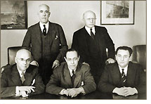SEC Commission (1939-1940): Edward C. Eicher (seated - left); Jerome N. Frank (seated - center); Robert E. Healy (standing - left); Leon Henderson (seated - right); George C. Mathews (standing - right)