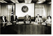 SEC Commission (1977): John R. Evans (second from right); Roberta S. Karmel (far right); Philip A. Loomis, Jr. (second from left); Irving M. Pollack (far left); Harold M. Williams (center)