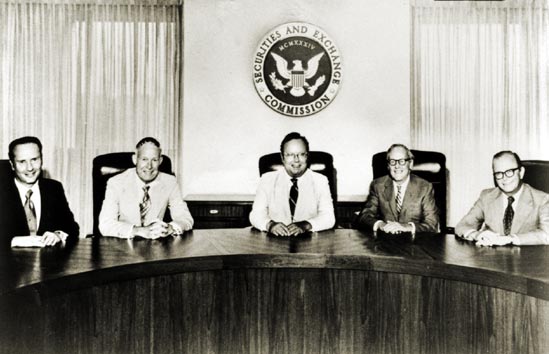 SEC Commission seated at a table beneath the SEC seal.