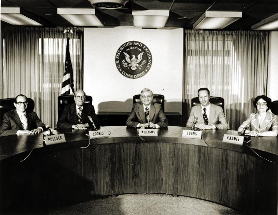 SEC Commission seated at a table, beneath the seal.