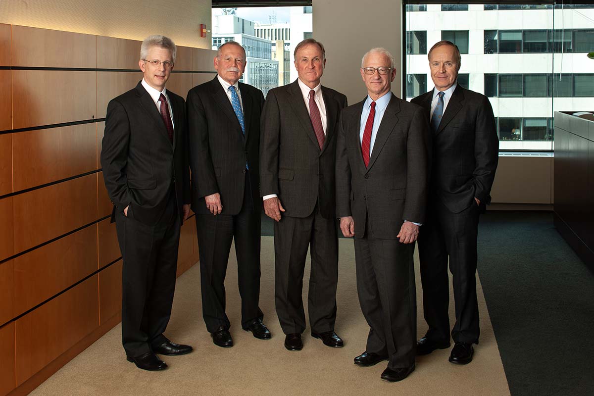 Group of PCAOB Board members standing in an office.