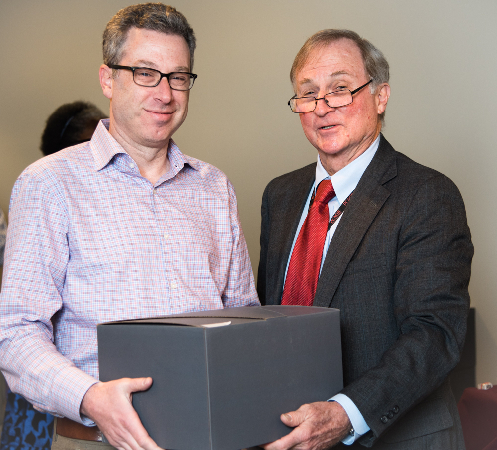 Jacob Lesser receiving a large gray box.