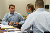 Georgia State University Investor Advocacy Clinic students Michal McLaughlin, Dylan Donley, and Russ Stroud interns working in a team discussing their case plans.