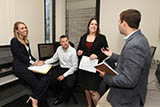 Georgia State University College of Law Investor Advocacy Clinic students present their proposal for a client matter and discuss it with Professor Iannarone in a supervision meeting.'