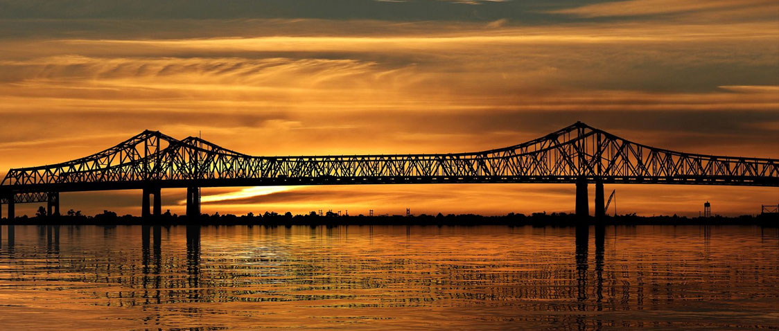 A bridge silhouetted against a sunset