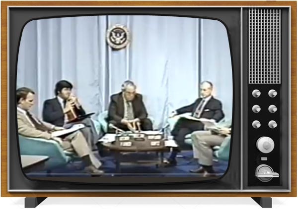 1980s style TV showing a panel discussion of four people.